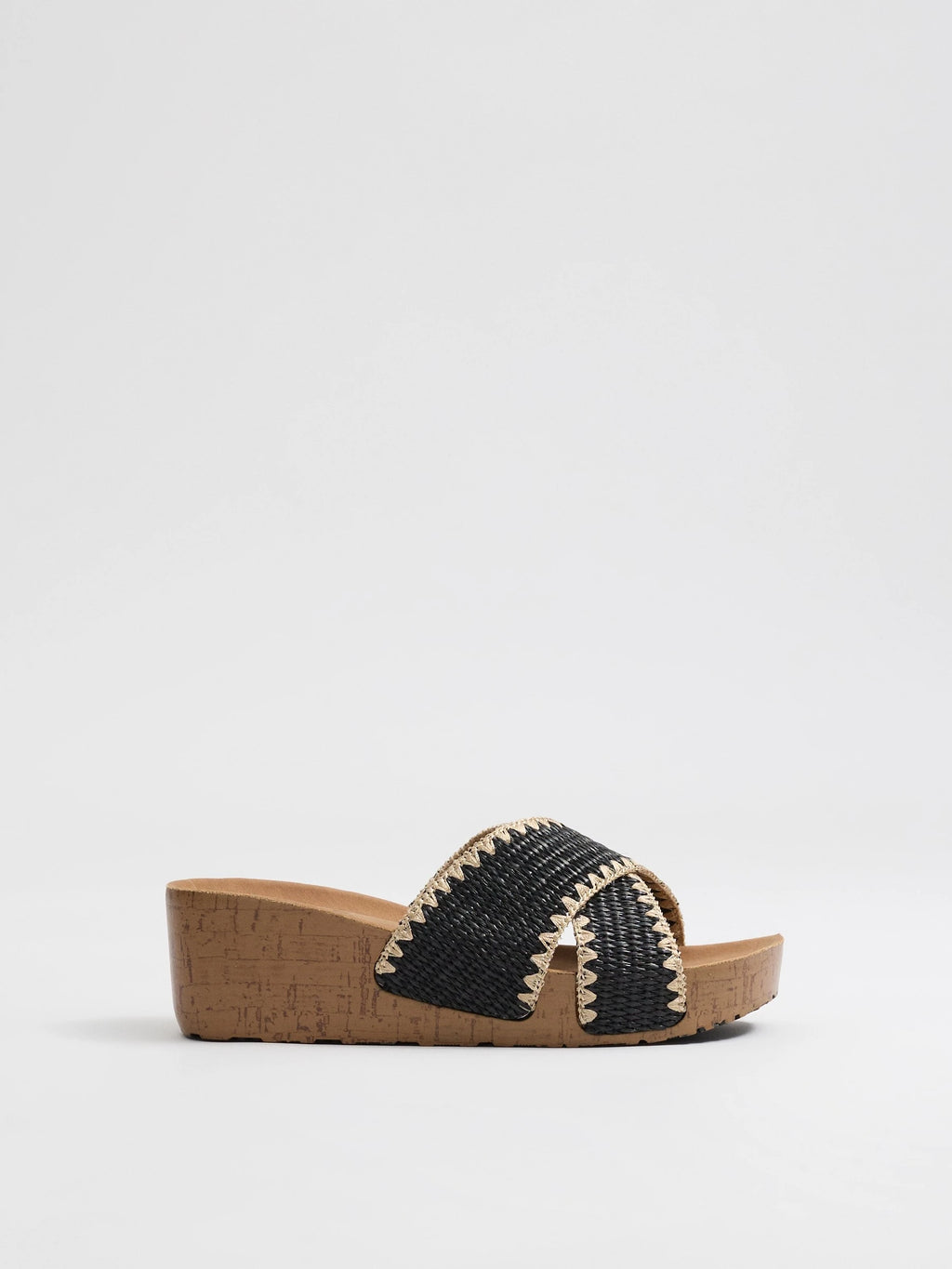 Wedges with black raffia crossed straps, zigzag stitching and cork base for comfort and craft style inside