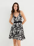Tropical black and white short dress with adjustable straps, V-neck, and flattering cut for women, featuring a stylish design perfect for casual occasions and parties.
