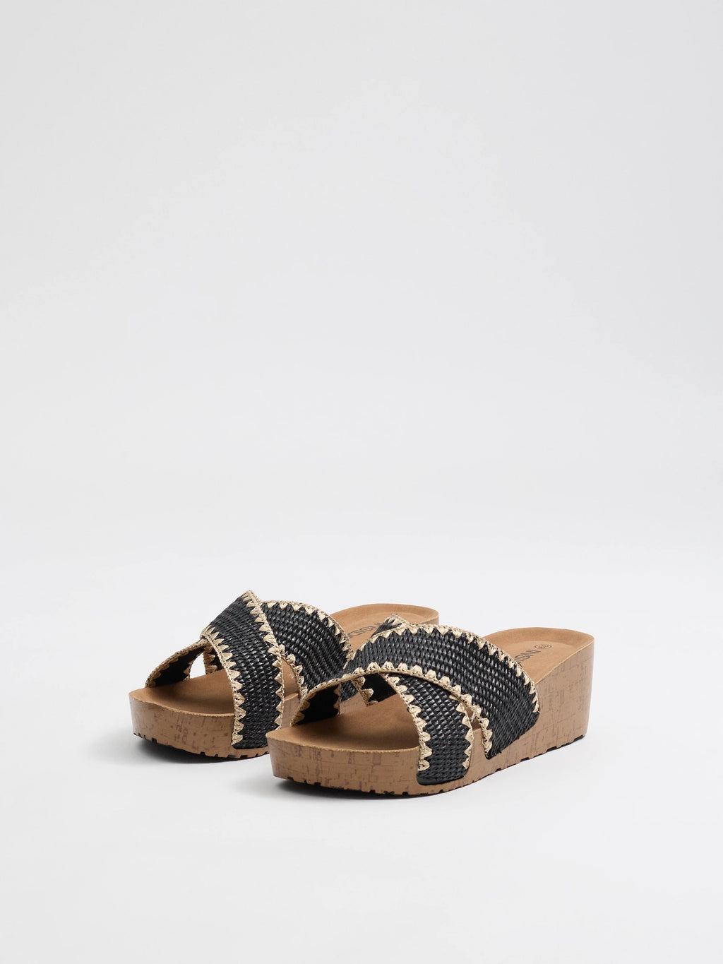 Wedges with black raffia crossed straps, zigzag stitching and cork base for comfort and craft style inside