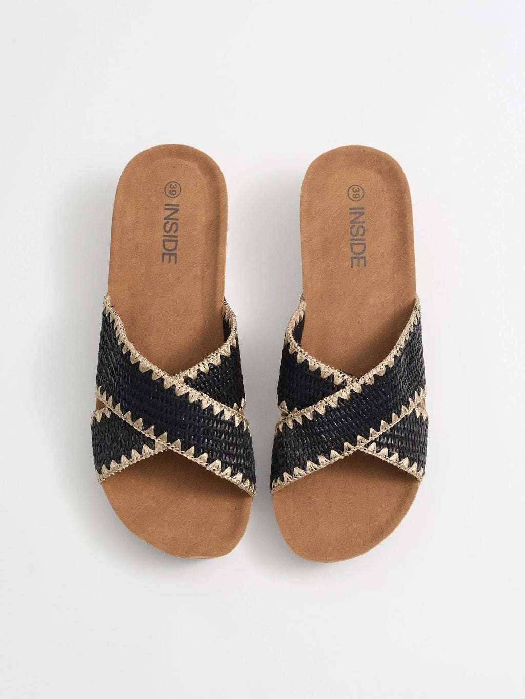 Wedges with black raffia crossed straps, zigzag stitching and cork base for comfort and craft style inside
