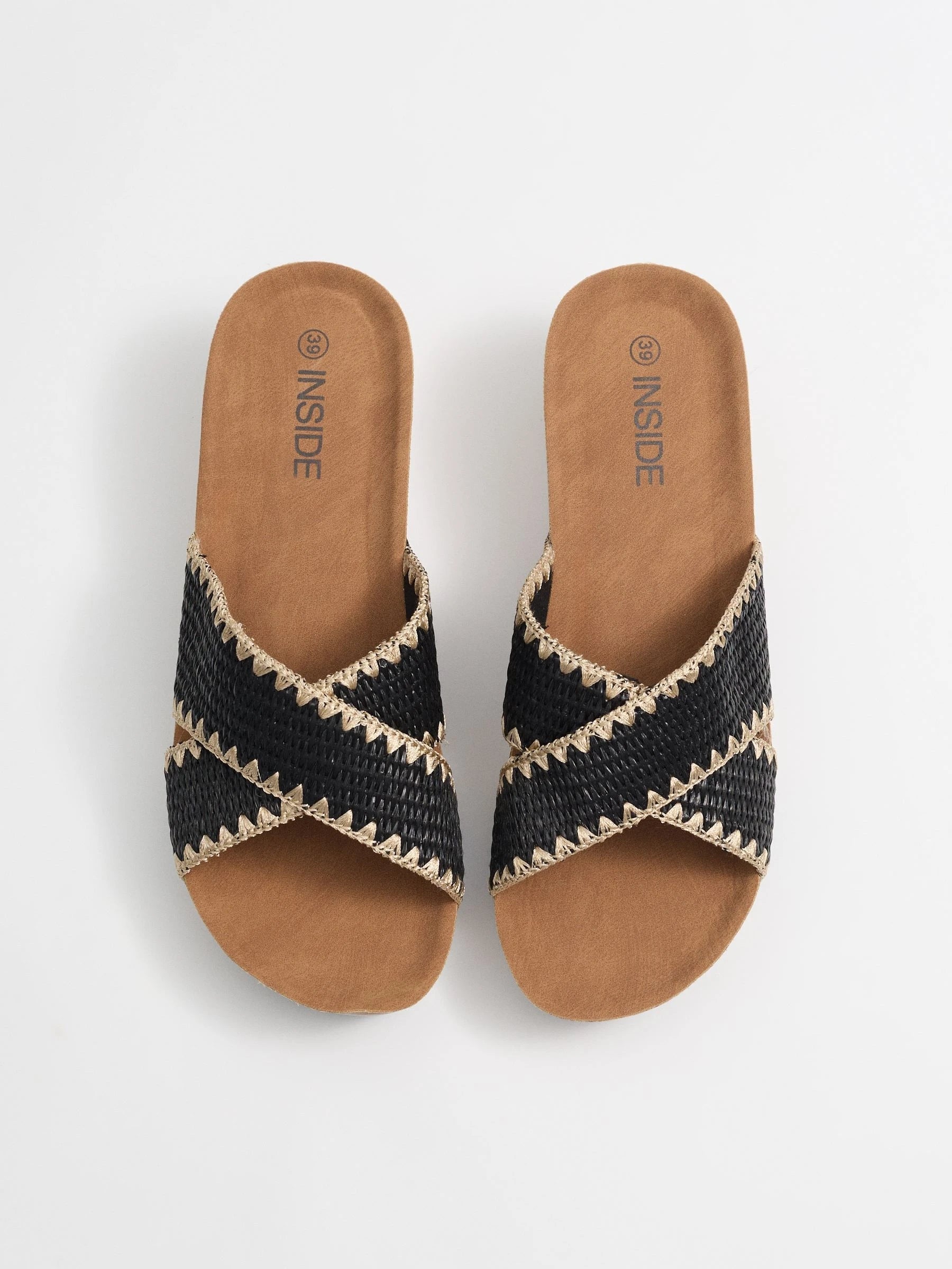 Wedges with black raffia crossed straps, zigzag stitching and cork base for comfort and craft style inside