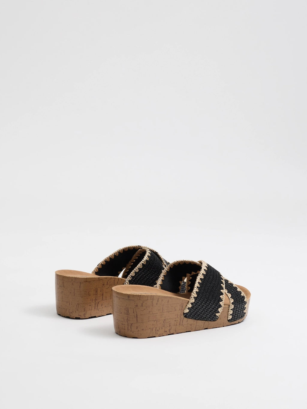 Wedges with black raffia crossed straps, zigzag stitching and cork base for comfort and craft style inside